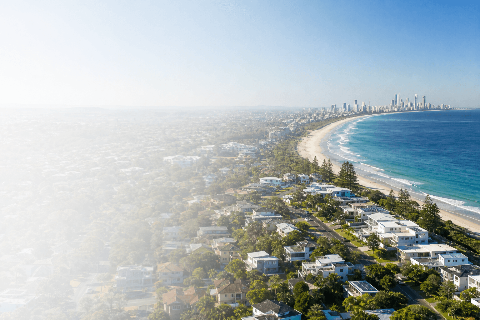Aerial view of Australian coastal homes and a city skyline